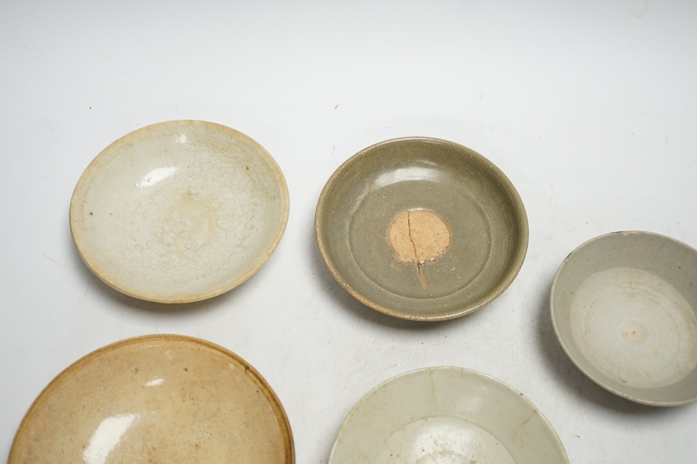 A group of seven Chinese Ding type, qingbai and celadon dishes, Song-Yuan dynasty, largest 15.5cm